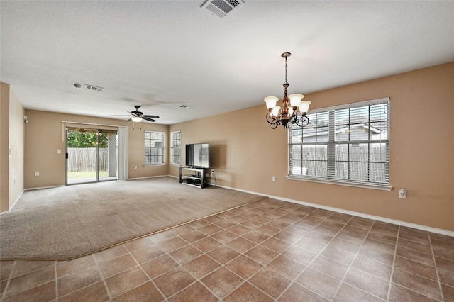 unfurnished living room with ceiling fan with notable chandelier and carpet floors