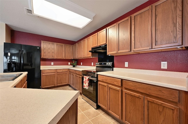 kitchen with light tile patterned floors, black refrigerator with ice dispenser, sink, and stainless steel range with electric cooktop