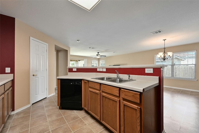 kitchen featuring hanging light fixtures, sink, a kitchen island with sink, dishwasher, and ceiling fan with notable chandelier