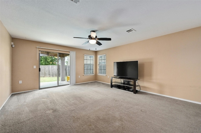 unfurnished living room featuring a textured ceiling, light carpet, and ceiling fan