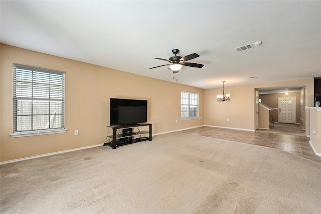 unfurnished living room with ceiling fan with notable chandelier and light colored carpet