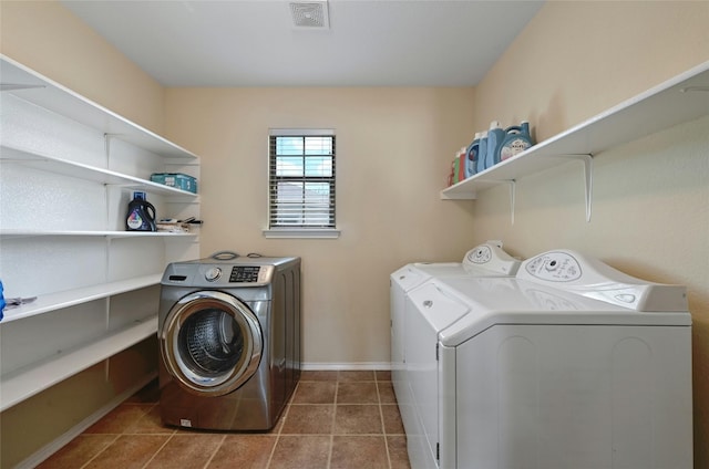 laundry room featuring separate washer and dryer and tile patterned floors