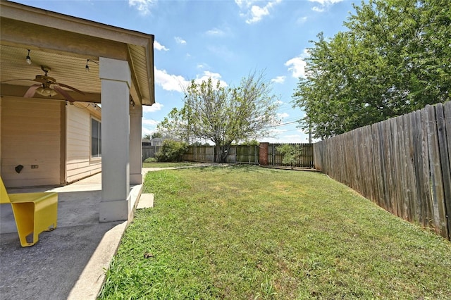 view of yard with ceiling fan and a patio