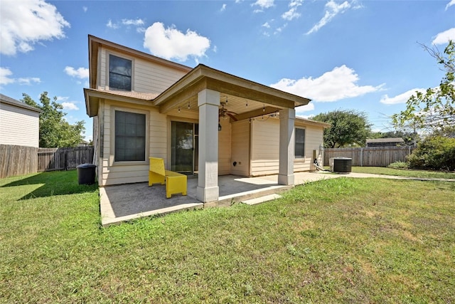 rear view of property featuring a lawn, a patio, and central AC unit