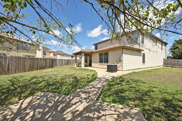 back of house with cooling unit, a fenced backyard, a patio, and a lawn