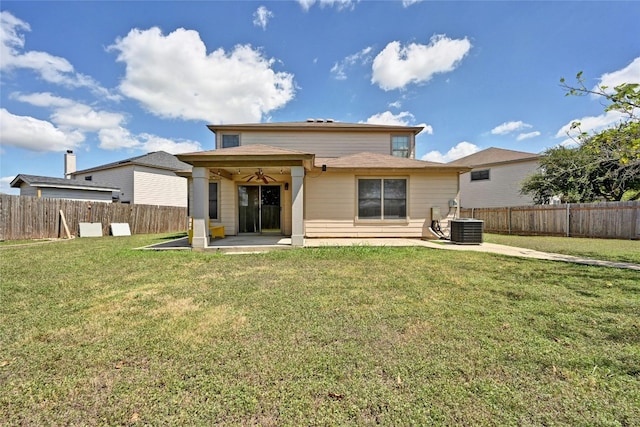 back of house with central AC, a patio area, a yard, and a fenced backyard