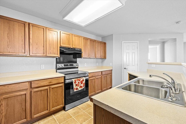 kitchen with under cabinet range hood, a sink, light countertops, stainless steel electric range, and brown cabinets