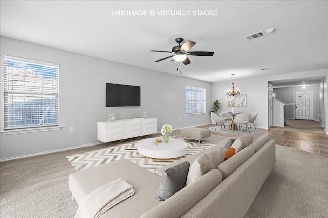 6507 Eudora Cv, Austin, TX 78747 - living area with baseboards, visible vents, and ceiling fan with notable chandelier