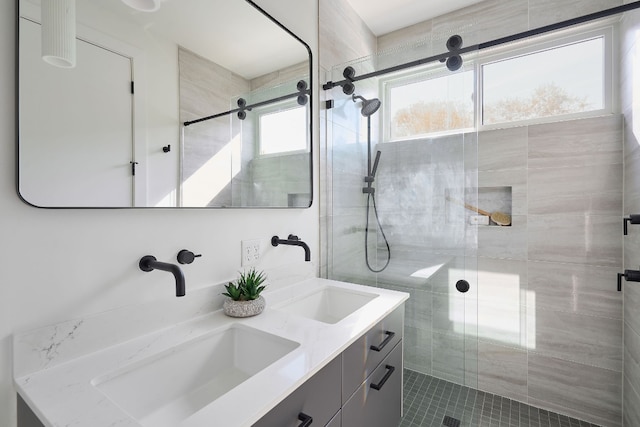 bathroom featuring tile patterned flooring, vanity, and a shower with shower door