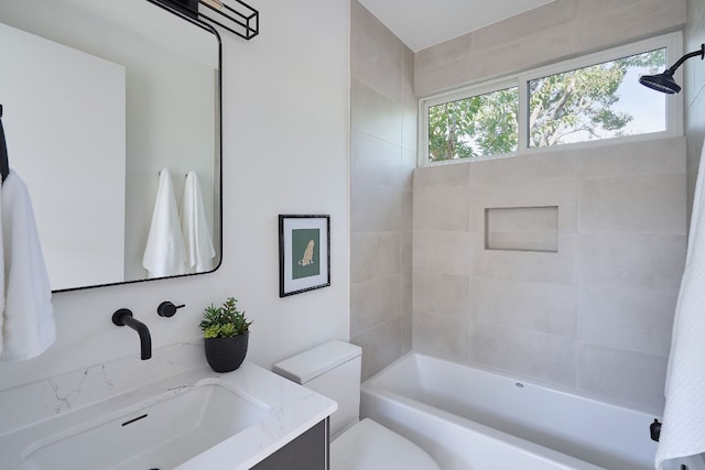 full bathroom with vanity, toilet, and tiled shower / bath