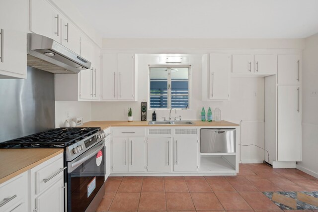 5807 Wynona Ave, Austin, TX 78756 - kitchen with stainless steel appliances, under cabinet range hood, light countertops, and white cabinets
