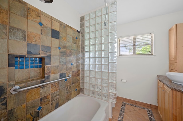 bathroom with tiled shower / bath, vanity, and tile patterned flooring