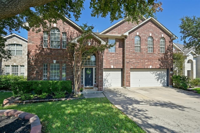 view of property featuring a garage and a front lawn