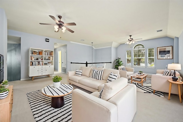 carpeted living room featuring vaulted ceiling and ceiling fan