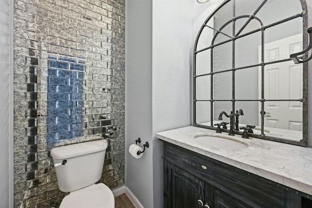 bathroom with hardwood / wood-style floors, vanity, and toilet