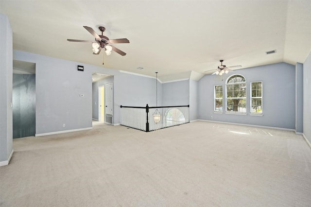 empty room with ceiling fan, light carpet, and vaulted ceiling