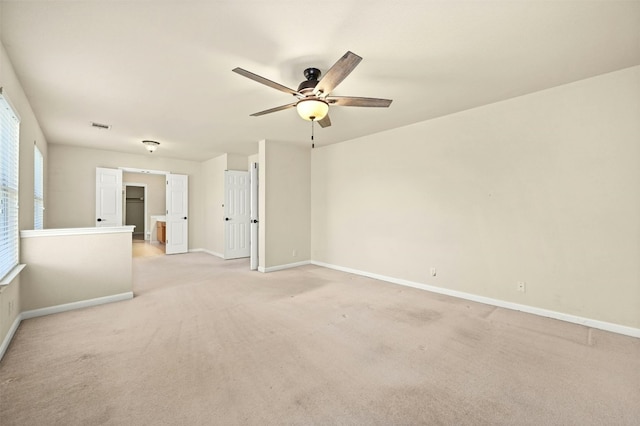 spare room featuring ceiling fan and light colored carpet