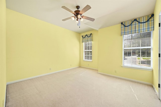 unfurnished room featuring ceiling fan and light colored carpet