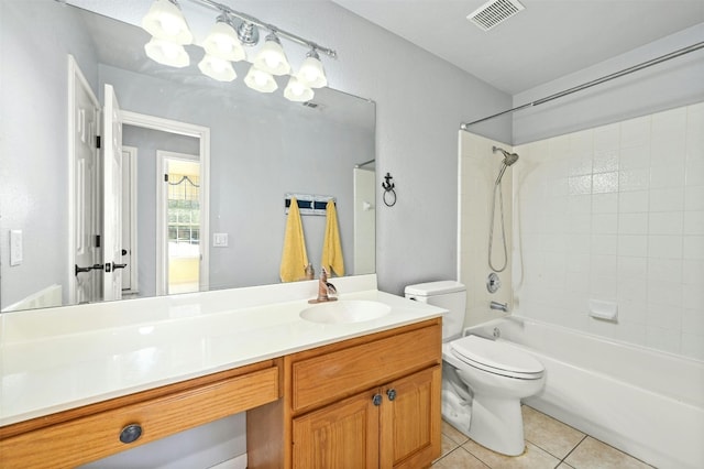 full bathroom featuring tiled shower / bath, vanity, toilet, and tile patterned floors