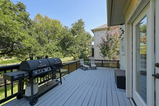 wooden terrace featuring area for grilling