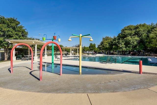 view of playground featuring a patio and a community pool