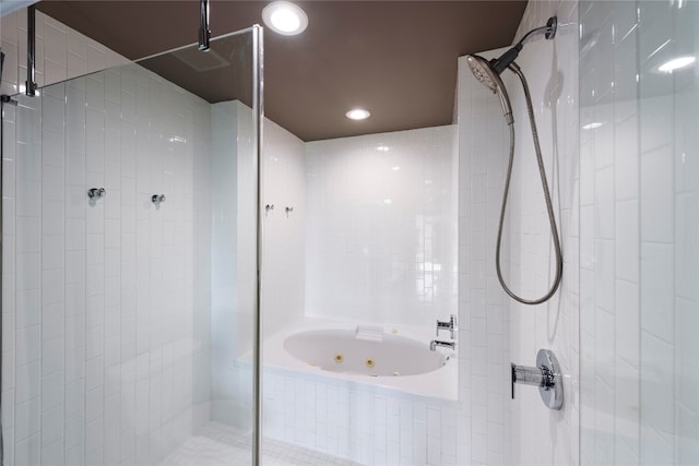 bathroom featuring separate shower and tub