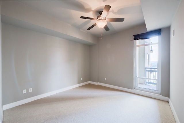 spare room featuring light colored carpet and ceiling fan