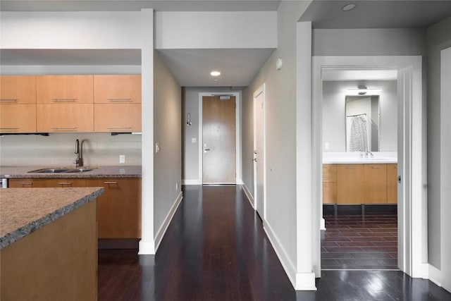 hallway with dark hardwood / wood-style flooring and sink