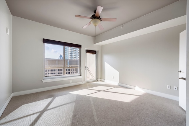 spare room with light colored carpet and ceiling fan