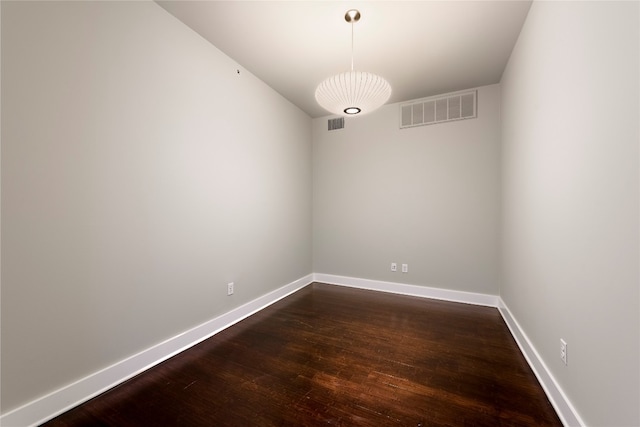 empty room featuring dark wood-type flooring