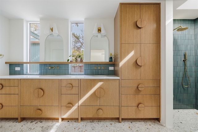 bathroom with backsplash, walk in shower, and a healthy amount of sunlight