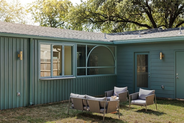 view of side of home featuring a lawn and an outdoor hangout area