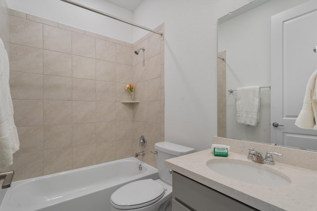 full bathroom featuring vanity, tiled shower / bath combo, and toilet