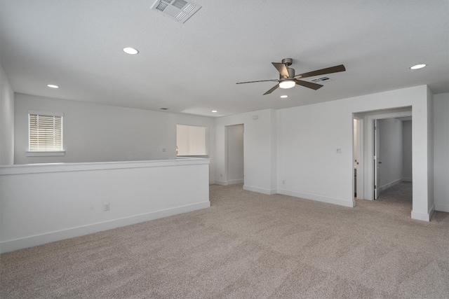 unfurnished room featuring ceiling fan and light colored carpet