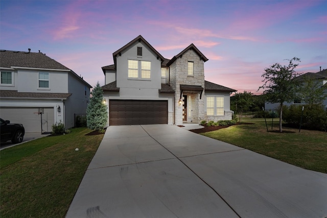 view of front facade with a yard and a garage