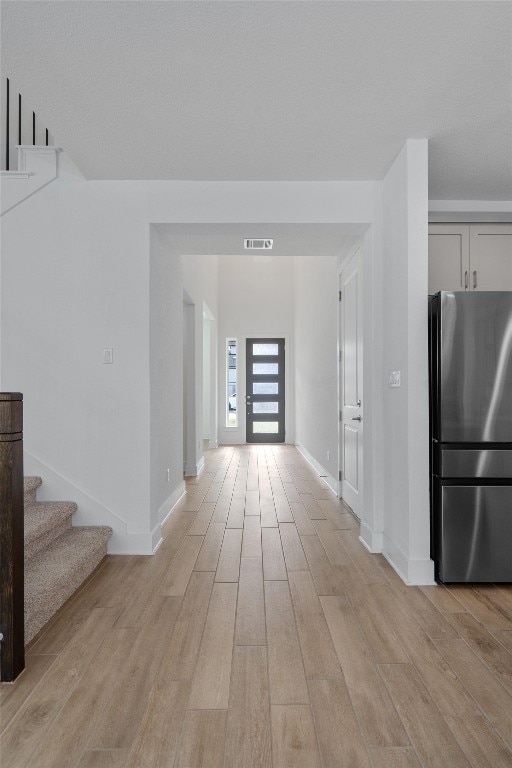 corridor featuring light hardwood / wood-style floors