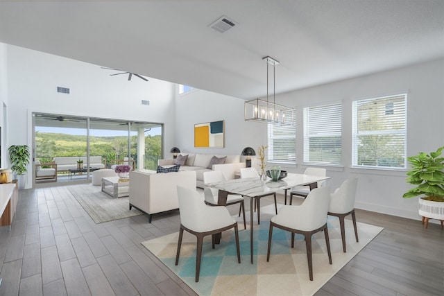 dining area featuring wood-type flooring and an inviting chandelier