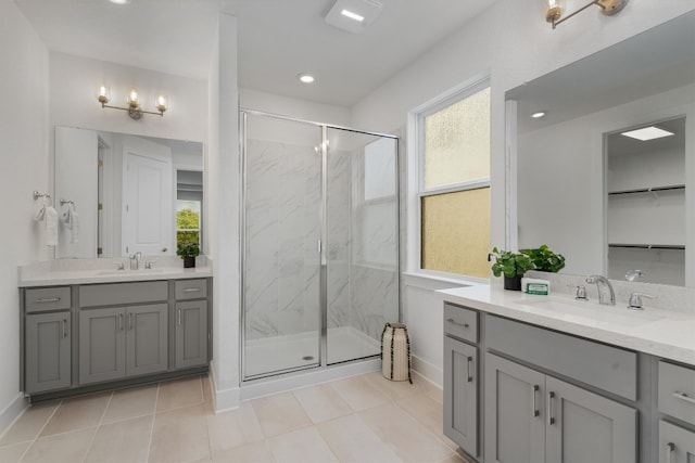 bathroom featuring vanity, a shower with door, tile patterned floors, and plenty of natural light