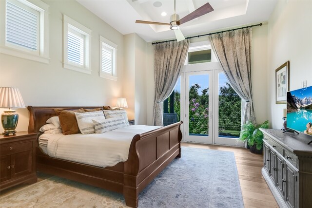 bedroom with multiple windows, access to outside, light hardwood / wood-style floors, and ceiling fan