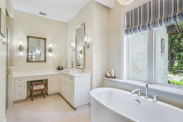 bathroom with vanity, tile patterned flooring, independent shower and bath, and a healthy amount of sunlight