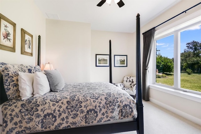 carpeted bedroom with ceiling fan and baseboards