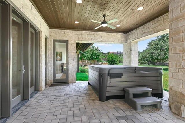 view of patio with a hot tub and ceiling fan