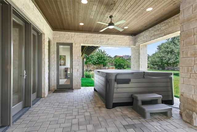 view of patio / terrace with a hot tub and ceiling fan