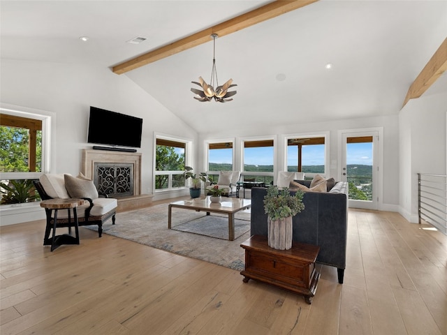 living room with high vaulted ceiling, light hardwood / wood-style floors, a premium fireplace, and beamed ceiling