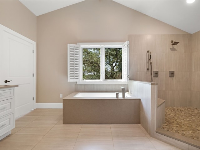 bathroom with vanity, lofted ceiling, plus walk in shower, and tile patterned floors