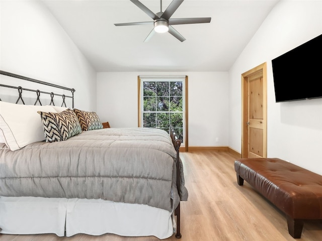 bedroom with light hardwood / wood-style flooring, lofted ceiling, and ceiling fan