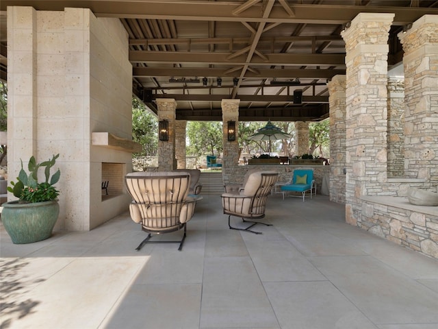 view of patio / terrace with a gazebo and an outdoor stone fireplace