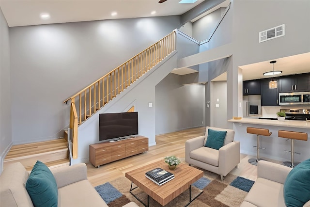 1707 Spyglass Dr Unit 60, Austin, TX 78746 - living area featuring light wood-style floors, stairway, a high ceiling, and recessed lighting