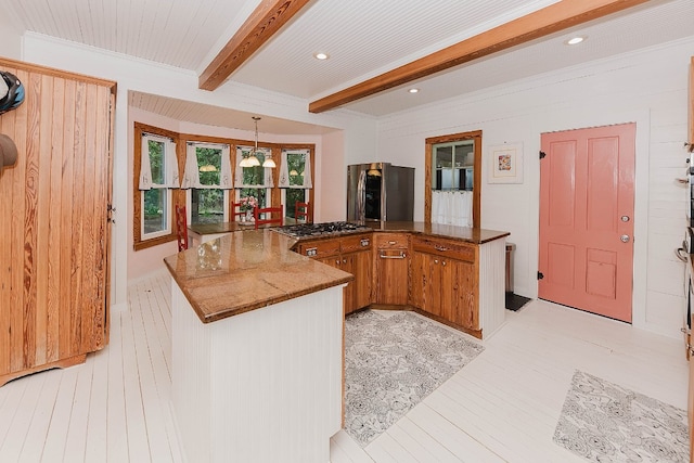 kitchen with light wood-type flooring, beam ceiling, kitchen peninsula, appliances with stainless steel finishes, and decorative light fixtures