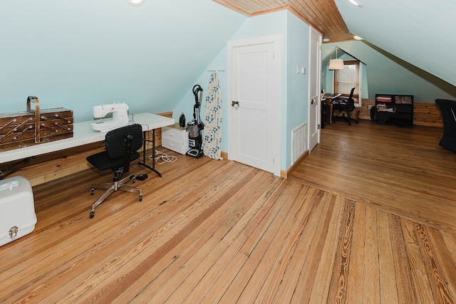 office with lofted ceiling and light hardwood / wood-style flooring